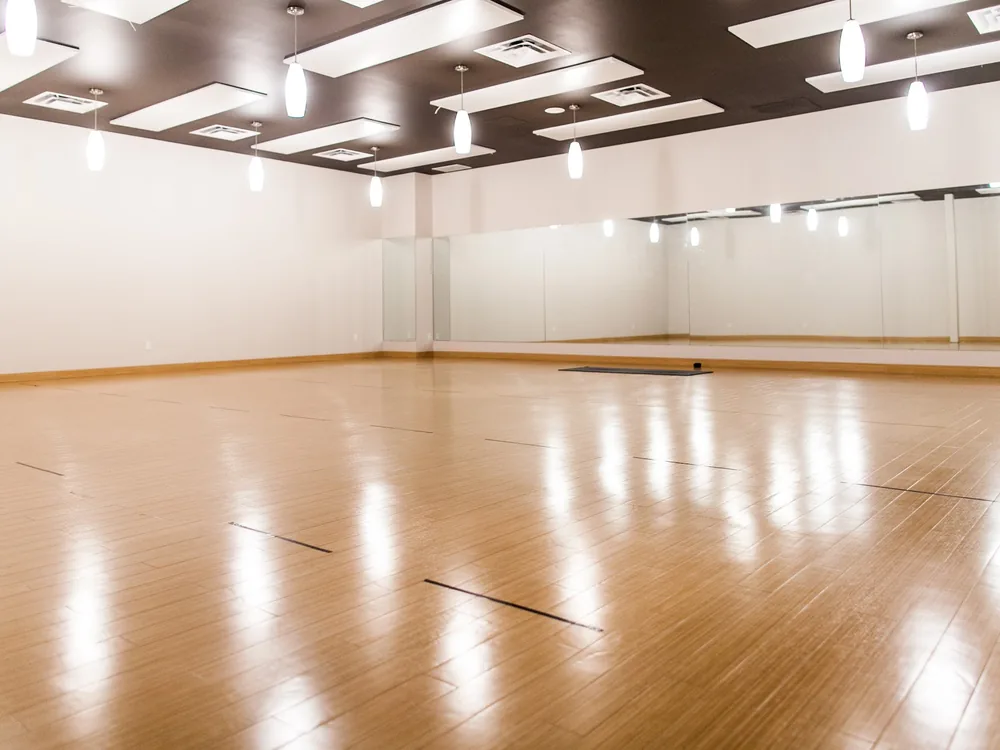 The warm-wood South Edmonton practice room, empty and ready for class.